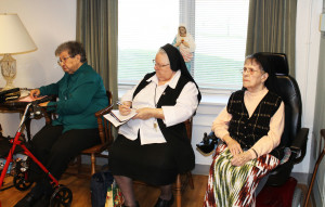 Listening intently, from left to right, are Sisters Ruth Mattingly, Catherine Marie Lauterwasser, and Marie Brenda Vowels.
