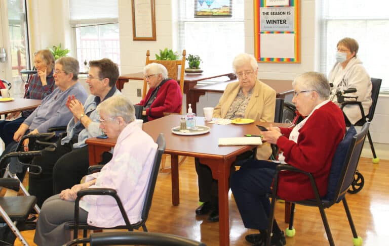 The Sisters were fascinated listening to Tsering discuss his prayer rituals and demonstrate some chants and music. From left are Sisters Marie Carol Cecil, Rose Jean Powers, Sharon Sullivan, Amanda Rose Mahoney, George Mary Hagan, Eva Boone, Ruth Gehres and Amelia Stenger.