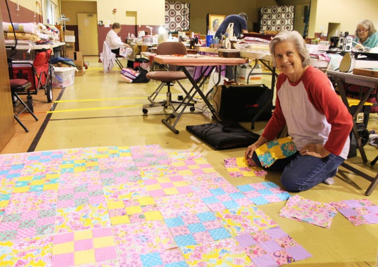 Marilyn Adkins, of Sacramento, Ky., pieces together her Scrappy Nine-Patch quilt that is designed for a teenage girl.
