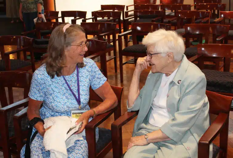 Carole Caummisar Sanders A’68, chats with Sister George Mary Hagan following Mass. Carole Caummisar Sanders A’68, chats with Sister George Mary Hagan following Mass.