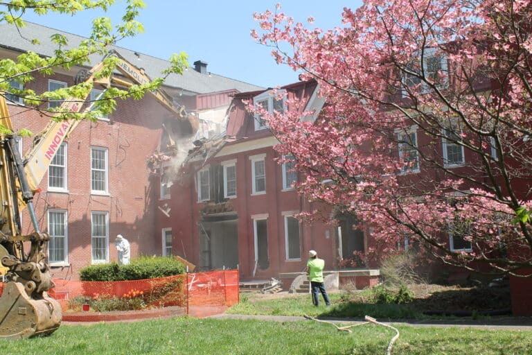 Deconstruction began about 12:30 p.m., on April 18, 2023, in the northern corner of the 1874 building.