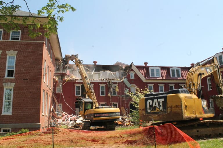 The top floor of the building was brought down first with a 70-foot excavator.