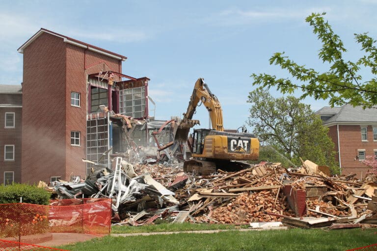 The excavator tears steel beems from the facade of the Retreat Center built in 1997. The excavator tears steel beems from the facade of the Retreat Center built in 1997.