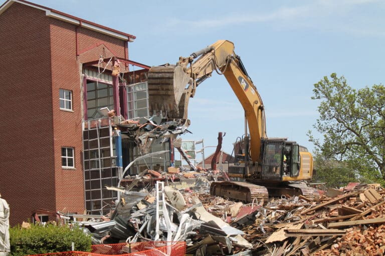 Two excavators were in use on April 20, with this one using jaws to grab and twist building materials. Two excavators were in use on April 20, with this one using jaws to grab and twist building materials.