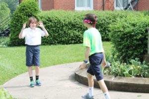 A student enthusiastically guides her friend in the right direction.