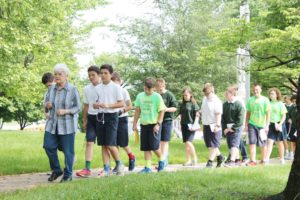Sister Cecilia Joseph Olinger leads a group of students in praying the rosary around the rosary walk.