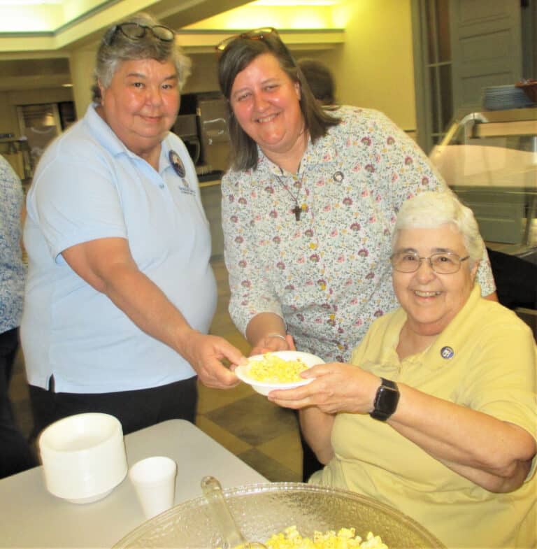 The tradition of Community Days is for members of the Leadership Council to serve treats to the Sisters following the opening address. Here, Councilors Sister Ann McGrew, right, and Sister Monica Seaton, center, make sure Sister Michele Ann Intravia gets a bowl of popcorn.