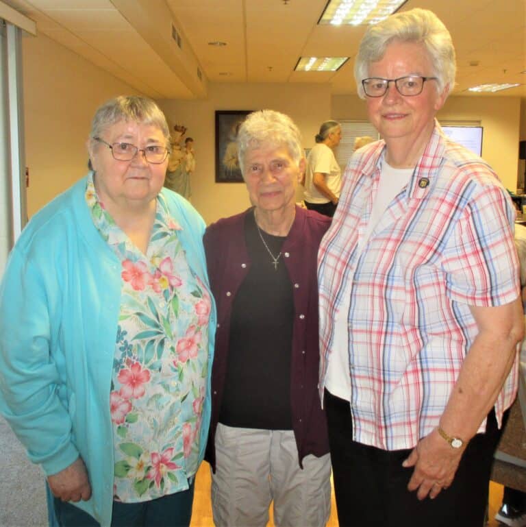 From left, Sister Joyce Marie Cecil, Sister Joan Riedley and Sister Mary Timothy Bland stop to pose for a photo. The three entered the community together 59 years ago.
