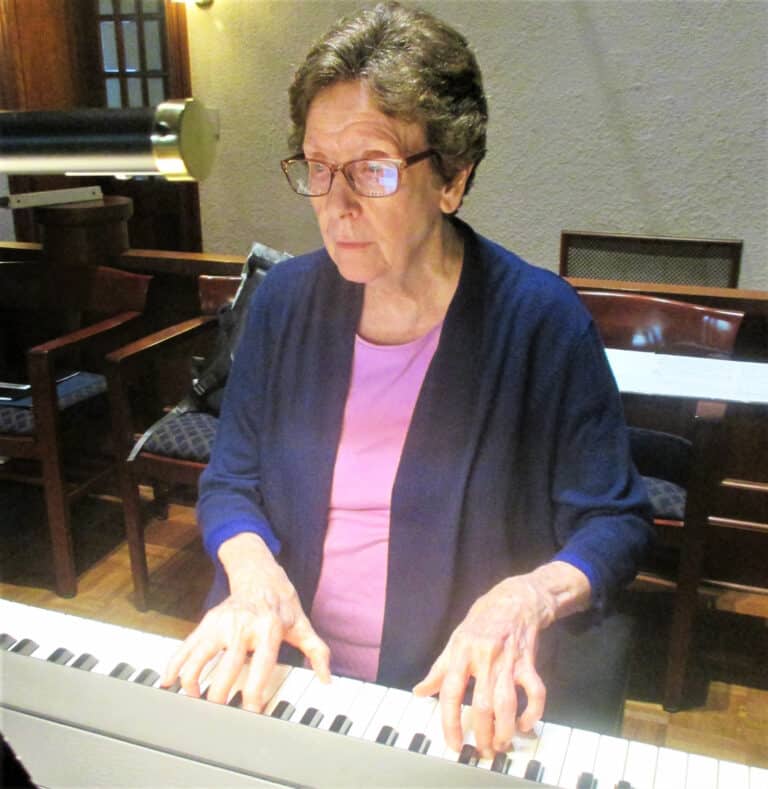 Sister Mary Henning, director of Worship for the Sisters, plays the piano for Mass on July 13.