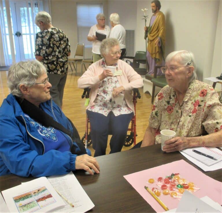 Sister Karla Kaelin, left, Sister Marie Joseph Coomes, center, and Sister Grace Simpson are in deep discussion about some topic. Sister Karla and Sister Grace both served in Louisville at the same time, and Sister Grace still volunteers there.