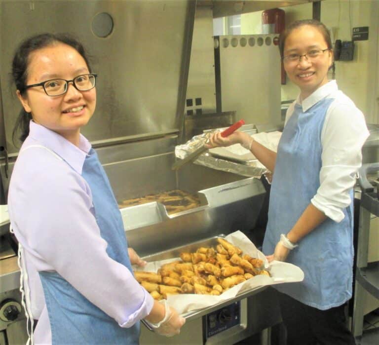 Sister Tien Mai, left, and Sister Cecilia, Vietnamese sisters visiting the Mount, make their delicious spring rolls for Community Days.