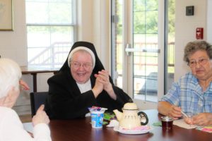 Sister Marian Powers smiles as she receives her prize of Oreos and candy bars.