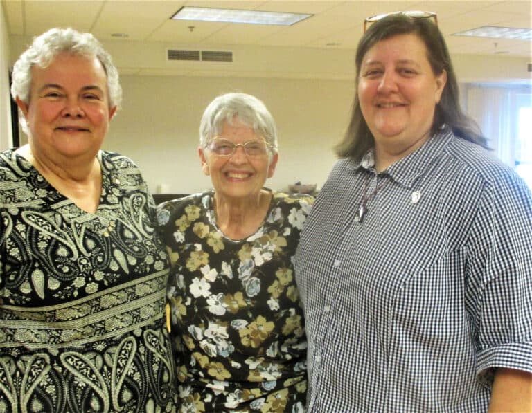 Sister Martha Keller, left, assistant congregational leader, and Sister Monica Seaton, a Leadership Council member, embrace Sister Mary Celine Weidenbenner, who is celebrating 60 years as an Ursuline this year.