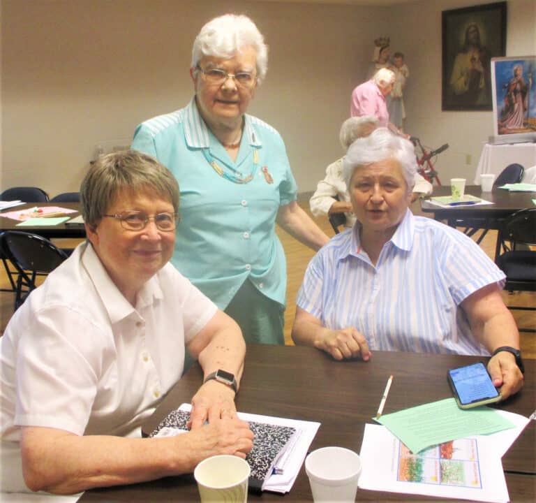 Sister Amelia Stenger, left, and Sister Cecelia Joseph Olinger, center, gather with Sister Carol Shively, who serves in Shreveport, La.