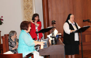The musicians for Mass were, from left, Sister Rosemary Keough, A’56, playing the flute; Tina Weber Smith, A’74, on the piano; Carolyn Sue Cecil, A’73, on the flute and Sister Catherine Marie Lauterwasser, A’55, the cantor.