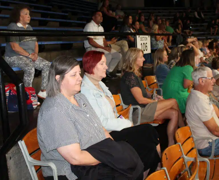 Ursuline Sister Monica Seaton, seated at left, awaits the Rainbow Mass to begin. Her great nephew carried in the flag representing Owensboro Catholic High School. Ursuline Sister Monica Seaton, seated at left, awaits the Rainbow Mass to begin. Her great nephew carried in the flag representing Owensboro Catholic High School.