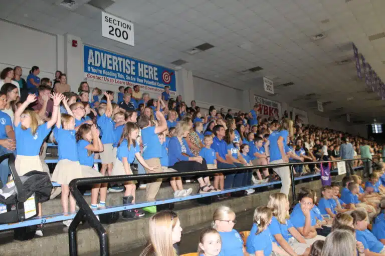 Students from St. Romuald School in Hardinsburg do the wave prior to Mass beginning. Students from St. Romuald School in Hardinsburg do the wave prior to Mass beginning.