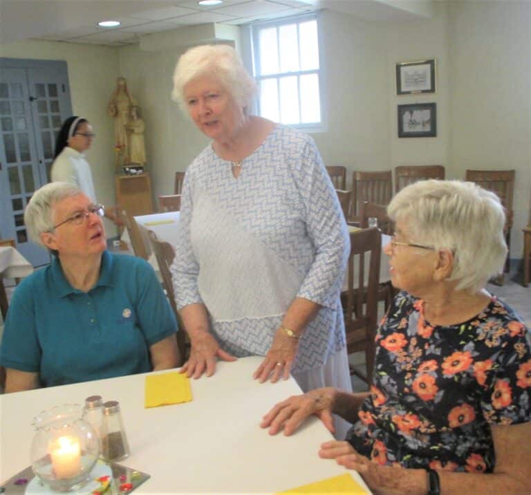 Sister Vivian Bowles, standing, tells a story as Sister Rita Scott, left, and Sister Jane Falke listen.