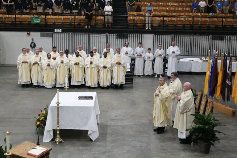 Bishop William Medley, right, flanked by several of the diocesan priests, addresses the students. He said he expected 3,000 people in attendance for the Rainbow Mass, “which makes me very happy.” Bishop William Medley, right, flanked by several of the diocesan priests, addresses the students. He said he expected 3,000 people in attendance for the Rainbow Mass, “which makes me very happy.”
