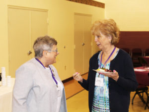 Sister Karla Kaelin, A’63, shares a laugh with Susan Thomas Allgeier, A’66 in the gymnasium prior to the banquet.