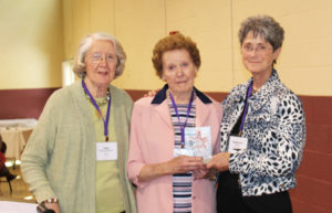 Stephanie Warren, A’73, right, vice president of the Alumnae Association, hands Patricia Sherron Ringswald, A’44, the Maple Leaf Award, as Joan Sherron Hofman, A’51, her sister’s nominator, joins them. Moments later, Warren would also win the award.