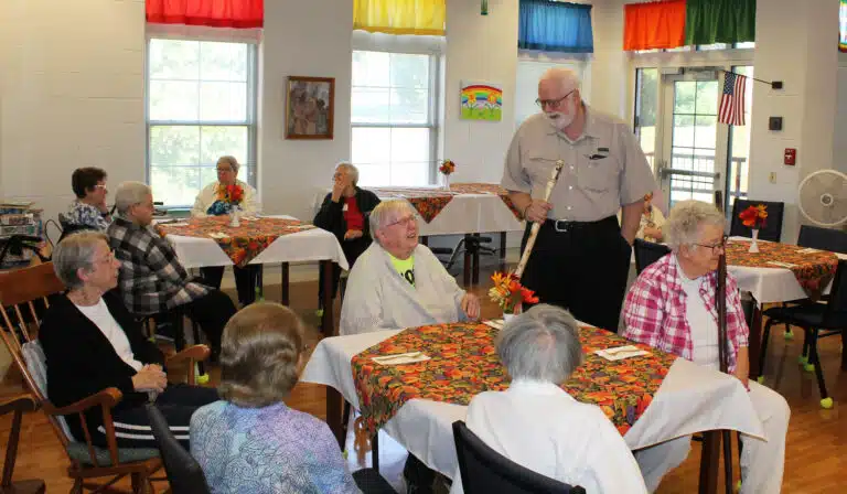 Father Ray Goetz laughs with Sister Grace Simpson, as Sister Maureen O’Neill, left, and Sister Michele Morek, right, listen.