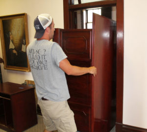 Spencer Hayden, with Pat Hayden Moving, helps move a desk out of Kris Mango’s office in St. Angela Hall. Construction of the building began in 1913, and it has served many roles through the years, including the home for those attending the Mount Saint Joseph Junior College from 1925-1950.