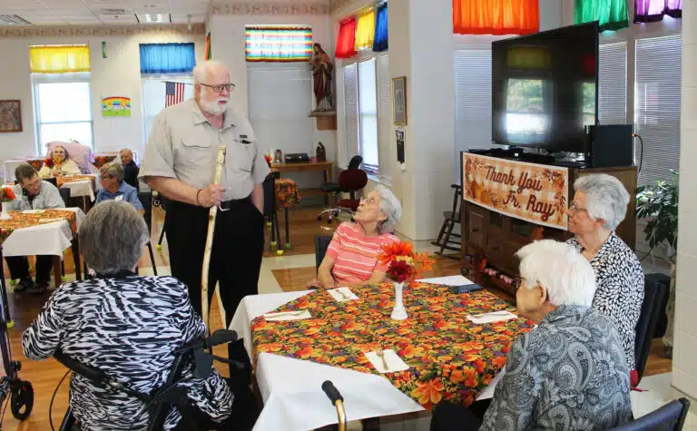 Father Ray shares some memories with, from left, Sisters Margaret Ann Aull, Elaine Burke, Mary Timothy Bland, and George Mary Hagan.