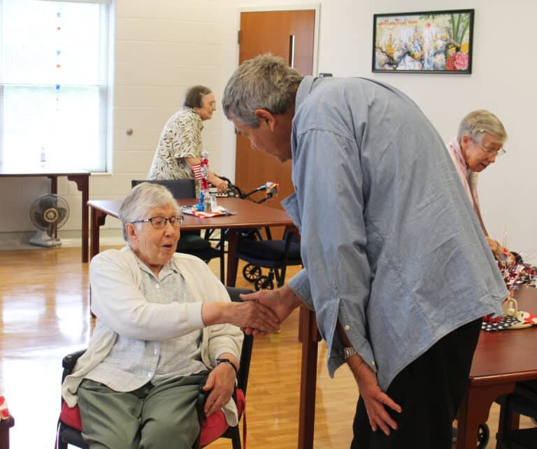 Sister Ruth Gehres greets Father Ray Clark. She taught him in an English class at Brescia College many years ago. Sister Ruth Gehres greets Father Ray Clark. She taught him in an English class at Brescia College many years ago.