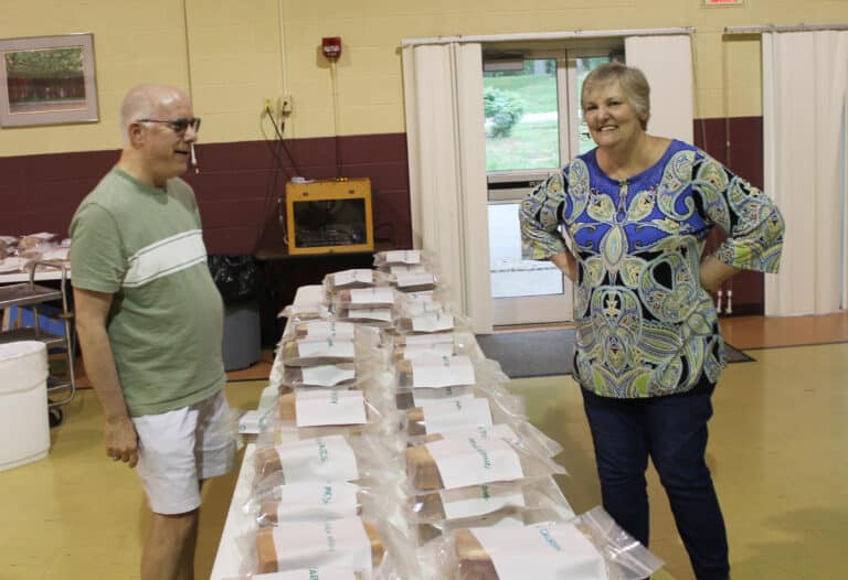 Steve Troutman, who taught at Mount Saint Joseph Academy, talks with Carol Braden-Clarke, director of Development for the Ursuline Sisters, while collecting his memorial brick.