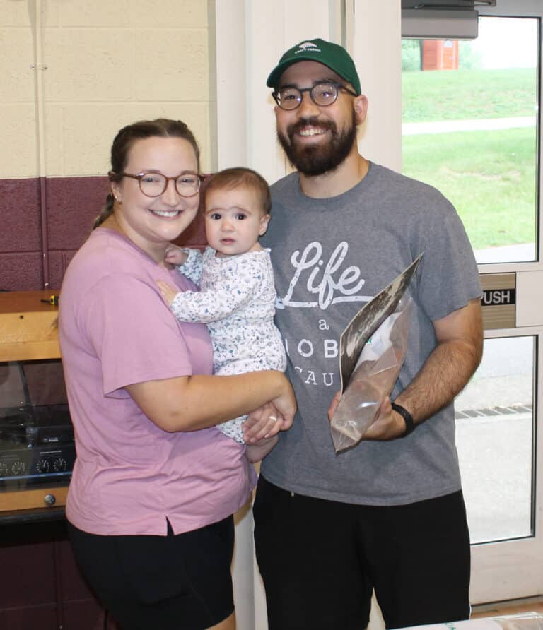 Emily and Jose' Solorza, and their 8-month-old daughter Ruth, pose after collecting their memorial brick.