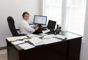 Sister Amelia Stenger types at her desk in Room 316 of Lourdes Hall on May 31. Sister Amelia will work in the Development office until she takes over as congregational leader July 17. Right now she has a view of the piazza.