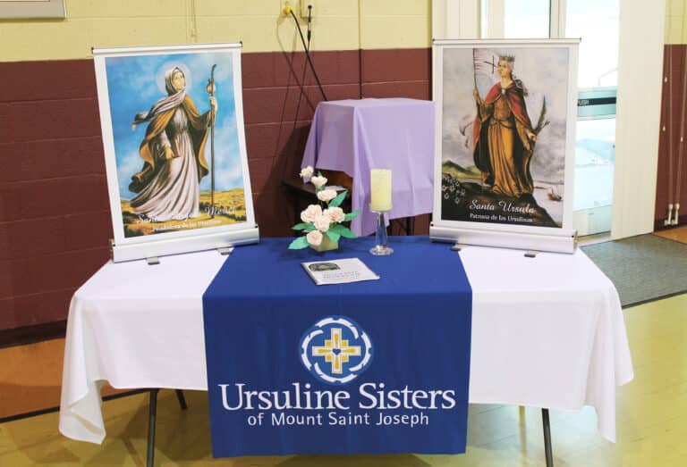 As part of the décor in Maple Hall, these banners of Saint Angela and Saint Ursula were on display, along with a copy of the Associate Handbook. Sister Betsy Moyer and Sister Monica Seaton, both on the Associate Advisory Board, set up the display and other decorations.