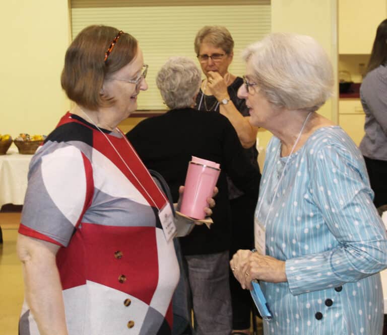 Sister Rebecca White, left, talks with Associate Pauline Goebel as the participants began to gather.