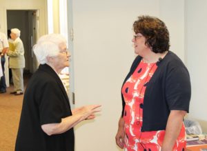 Sister Mary Matthias Ward, left, director of the Mount Saint Joseph Conference and Retreat Center, talks with Lisa M. Gulino prior to the program.