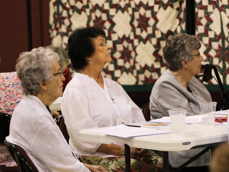 Sister Ann Patrice Cecil, left, Linda Rocco of Owensboro, center, and Sister Margaret Ann Aull listen to Sister Cheryl. Linda made her Associate commitment later in the day.