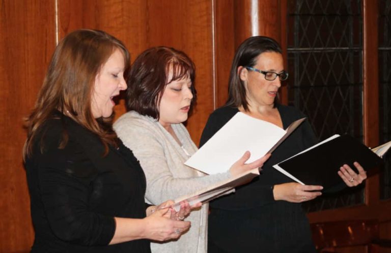Leslie Pfingston, left, alto; Melissa Zink, center, soprano; and Olivia Terry, soprano, sing the opening song, “Baptized in Living Waters.” All the singers and musicians are members of Holy Spirit Church in Bowling Green, Ky.