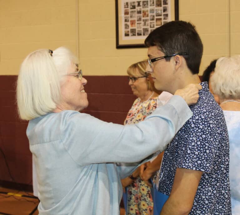 Sister Nancy Liddy places the Associate pin on new Associate Wes Wheatley. Sister Nancy was his contact Sister during formation.