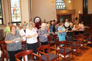 Ursuline Associates and Sisters sing “All Are Welcome” at the opening of the Associate Commitment ceremony in the Motherhouse Chapel. The commitment ceremony was held earlier in the day separate from Mass this year.