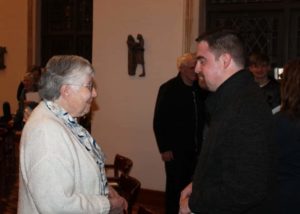 Sister Ruth Gehres congratulates Corey Bruns on his composition after the concert. Sister Ruth and Sister Grace Swift were among 11 people who submitted musical pieces in the competition, which was judged by three people outside the diocese.