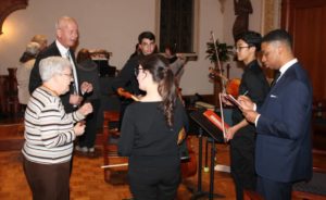 Sister Cecelia Joseph Olinger, a church musician herself, congratulates the musicians along with Mike Bogdan.