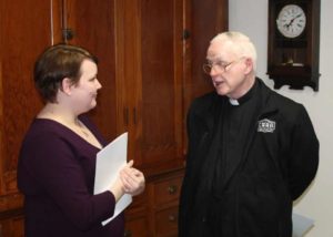 Heidi Taylor-Caudill talks with Father Meinrad Brune, archivist at St. Meinrad Archabbey, during the reception following the concert.