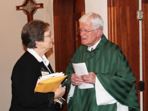Sister Amelia Stenger talks with Father Joe Mills prior to Mass. Father Mills is celebrating 30 years as an Ursuline Associate.