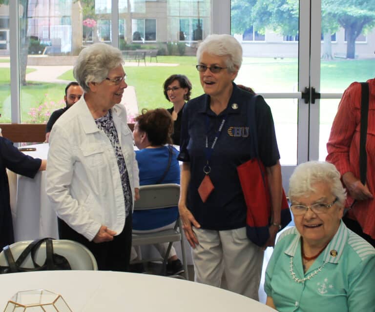 Sister Nancy Murphy, left, and Sister Barbara Jean Head, are joined by Sister Cecelia Joseph Olinger (seated) among the Ursulines there to support Sister Vivian.
