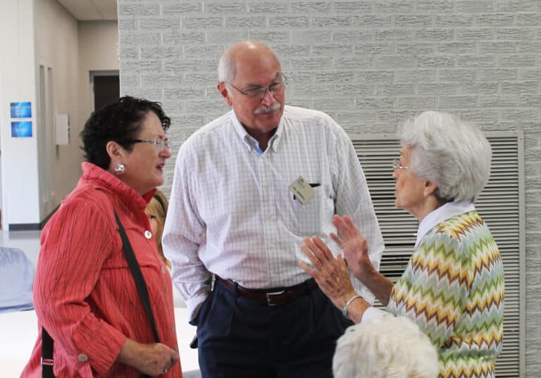 Sister Elaine Burke, right, talks with Brescia alums Carl and Molly Greenwell.