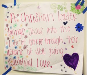 One of the posters hanging in the conference room defines how one group describes a Christian leader.