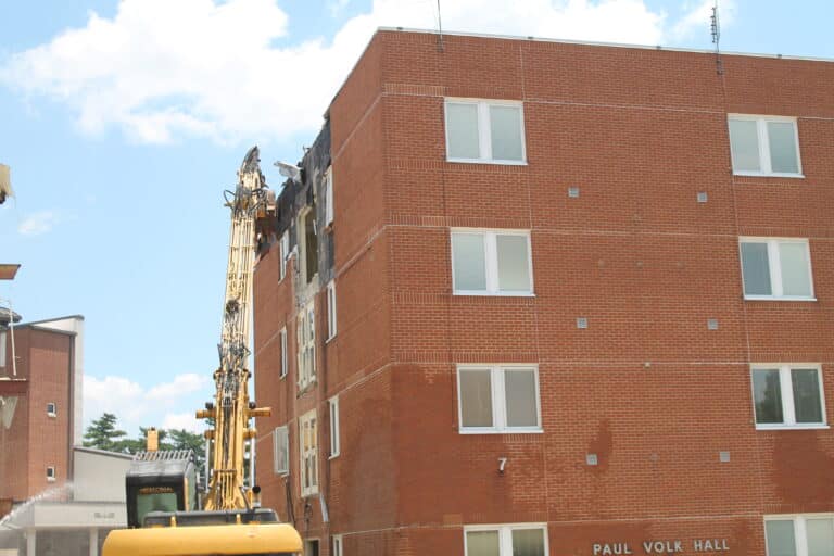 Deconstruction began in the morning, with excavators stripping the bricks from the concrete building.