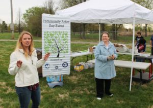 Sondra Hagan, left, an engineering technician with the city of Owensboro, instructs the volunteers on how to plant the trees. Sister Amelia Stenger, right, welcomed and thanked everyone who donated and who came to volunteer.