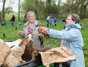 Carol Braden-Clarke, left, director of development for the Ursuline Sisters, takes some trees to plant from Sister Amelia Stenger.