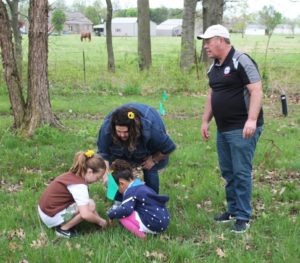 City Commissioner Larry Conder helped these young volunteers plant many trees. The location was chosen to help the nearby Thompson-Berry ditch stay clean and reduce erosion.